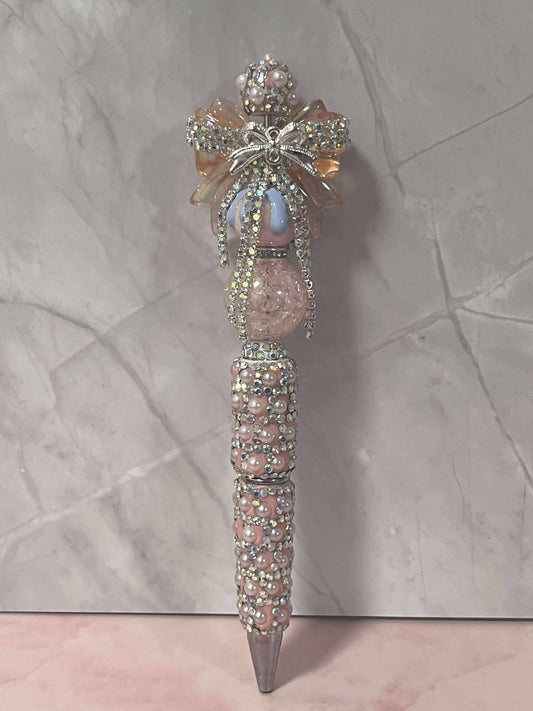 peach bedazzled bow on a pink pen